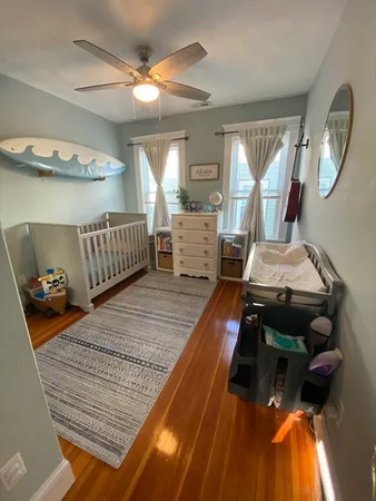 a bedroom with furniture and a wooden floor