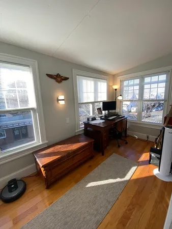 a living room with furniture a flat screen tv and a window