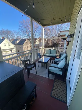 a outdoor living space with furniture and a rug