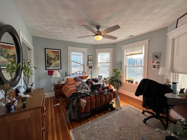 a bedroom with furniture and a large window