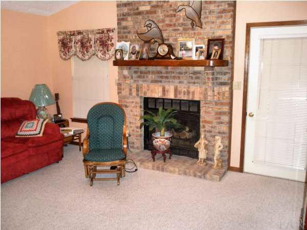 2367 Valley Road Navarre, FL 32566 - Photo 2 of 10 Family room with vaulted ceiling and gorgeous floor to ceiling brick fireplace with wood mantel