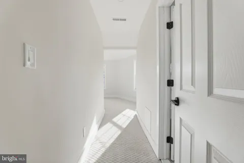 a view of a bathroom from a hallway