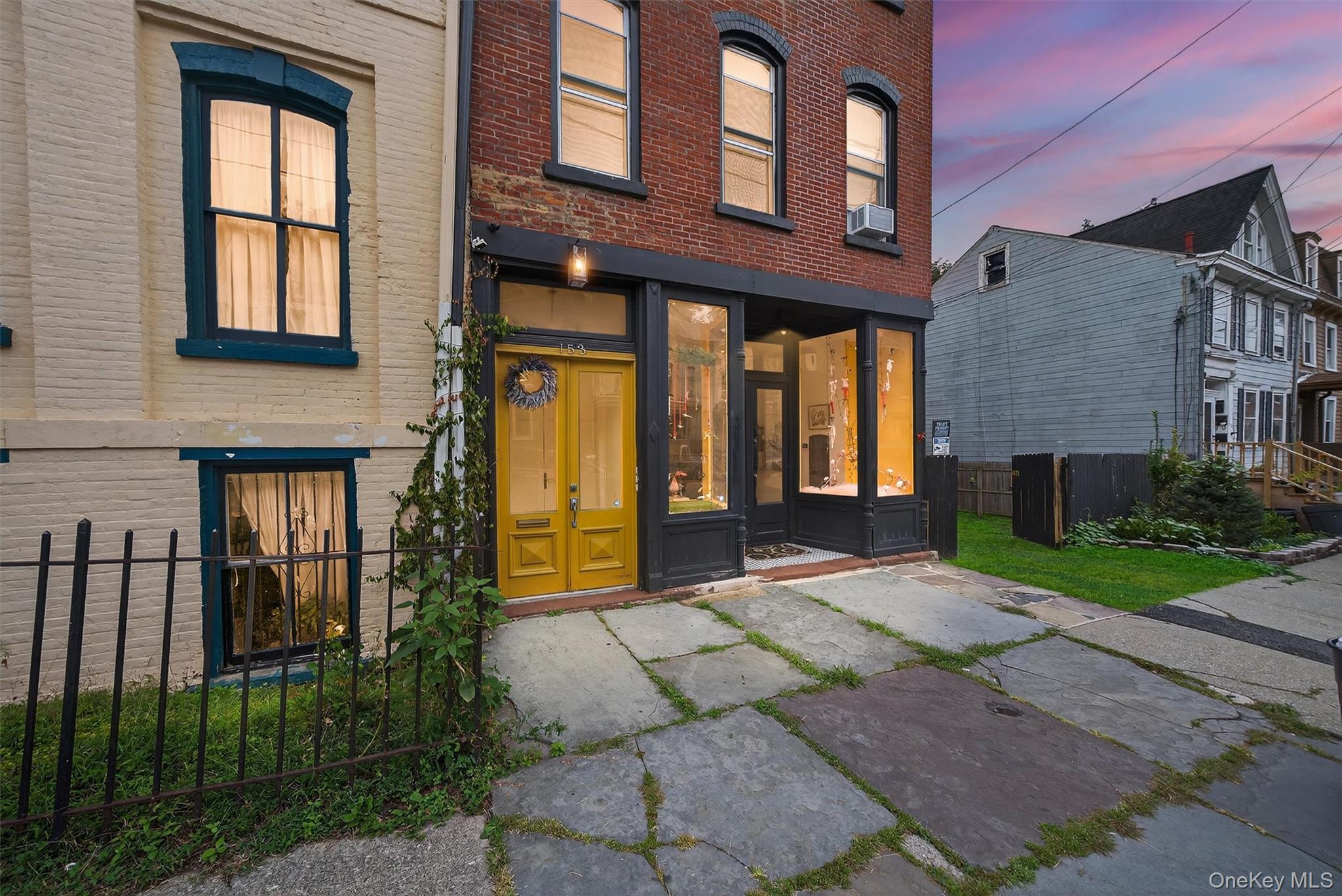 a front view of a house with garden