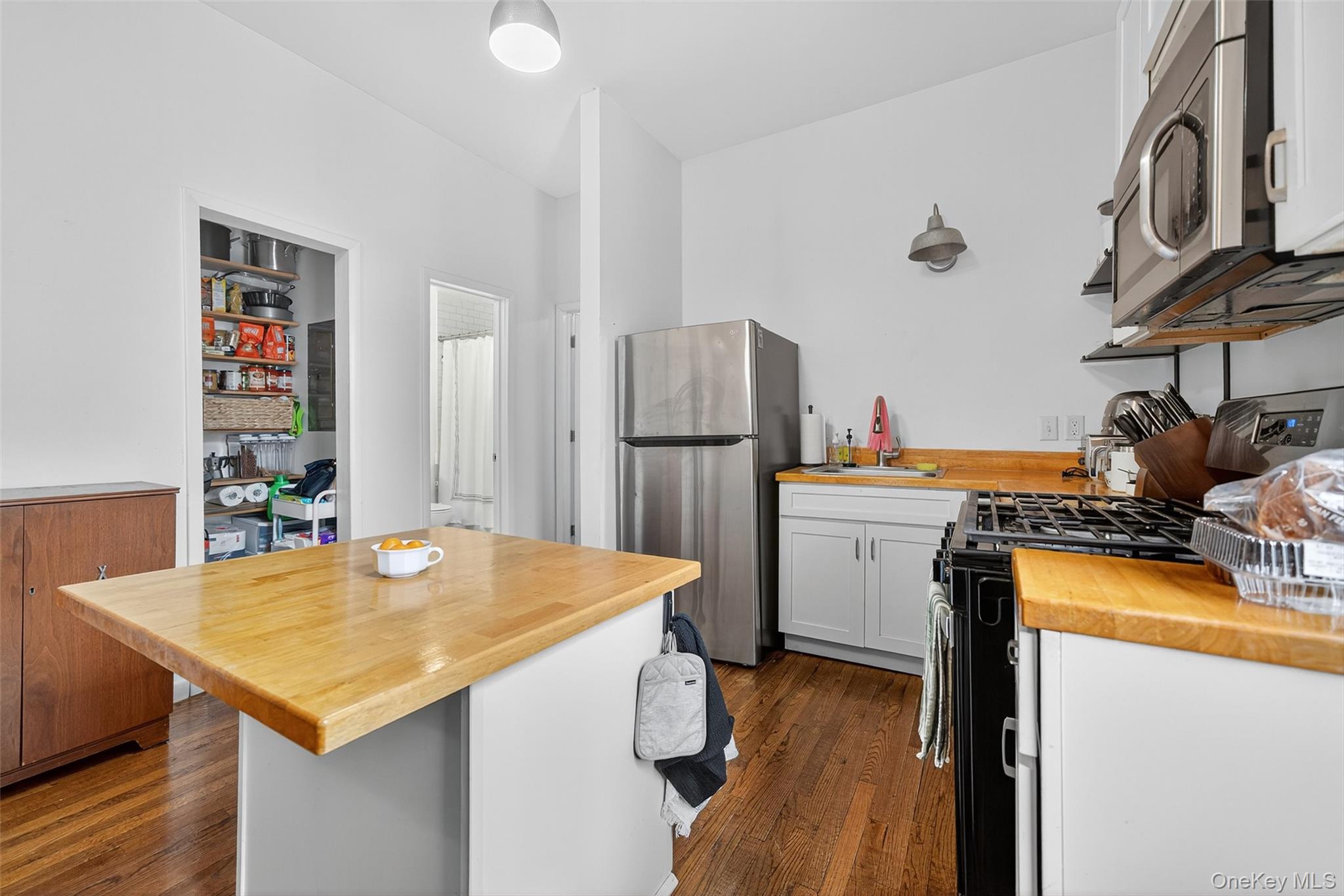 153 Lander Street Newburgh, NY 12550 - Photo 23 of 39 a kitchen with a table chairs refrigerator and stove
