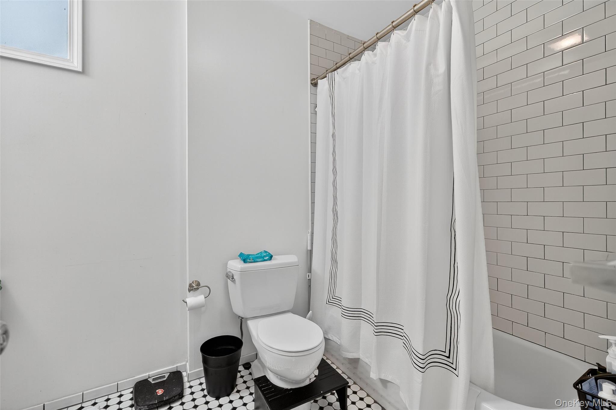 153 Lander Street Newburgh, NY 12550 - Photo 24 of 39 a white toilet sitting next to a shower curtain