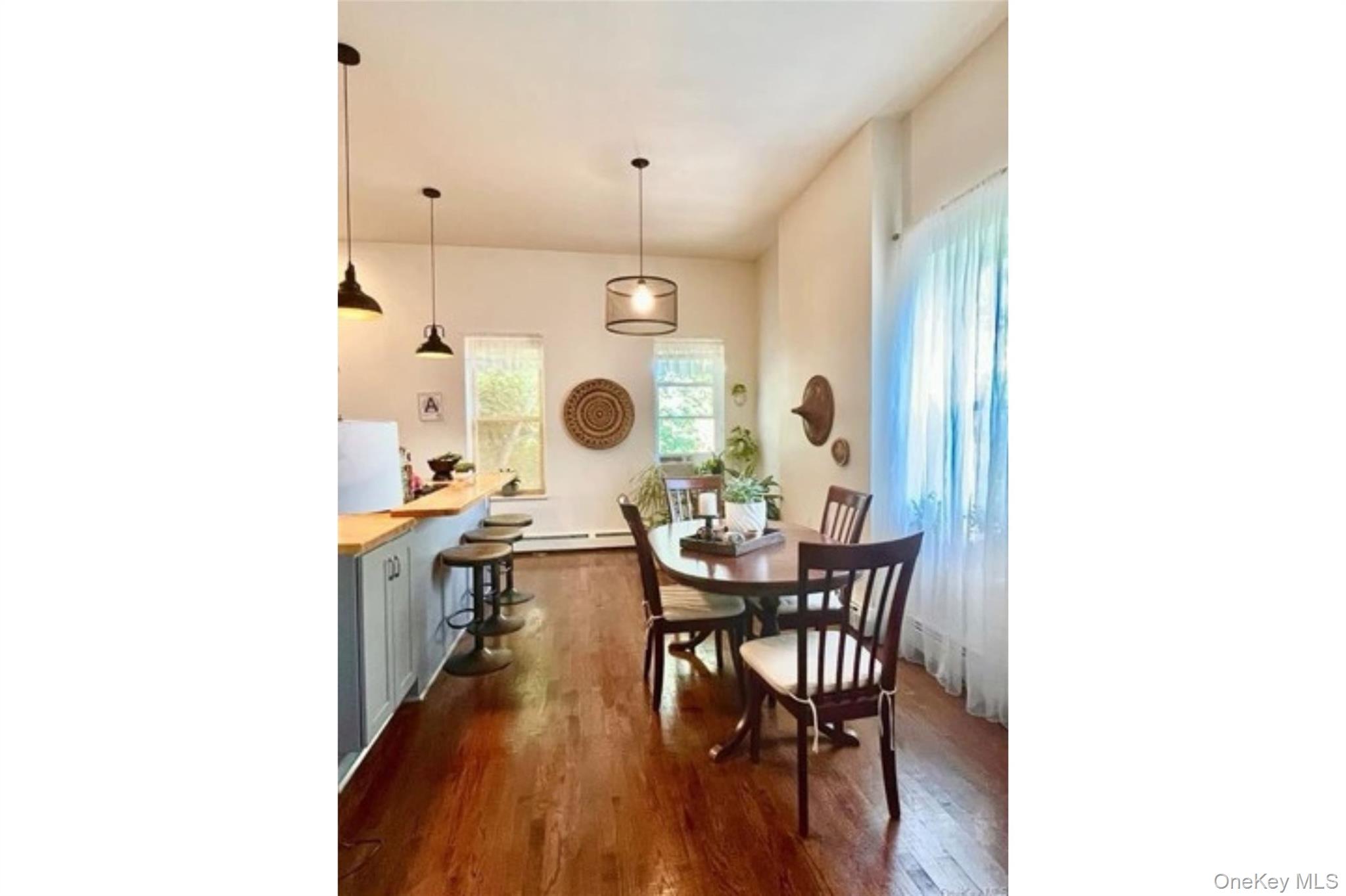 153 Lander Street Newburgh, NY 12550 - Photo 3 of 39 a dining room with kitchen island a wooden floor and breakfast area
