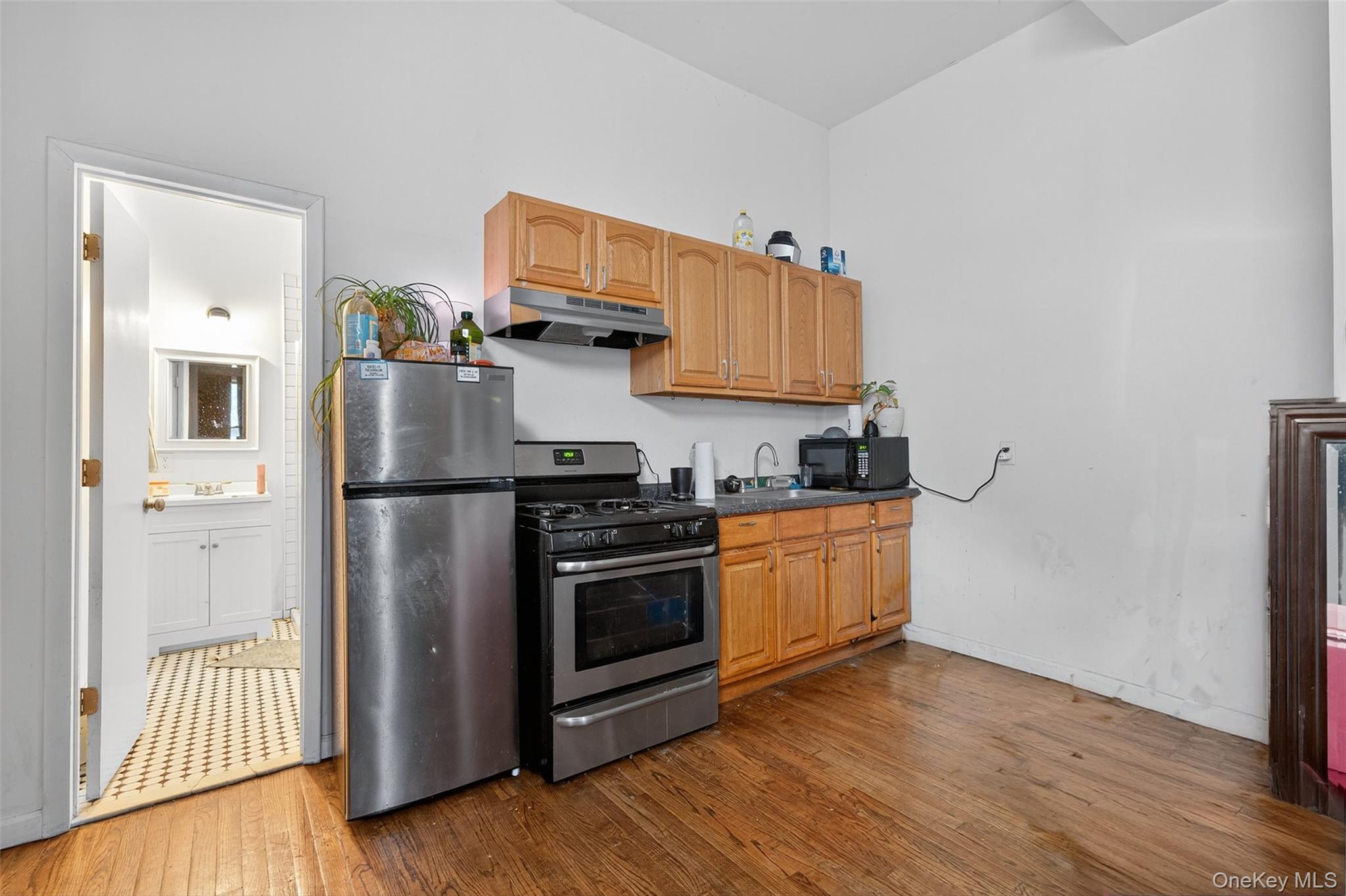 153 Lander Street Newburgh, NY 12550 - Photo 33 of 39 a kitchen with stainless steel appliances a refrigerator stove and wooden floor