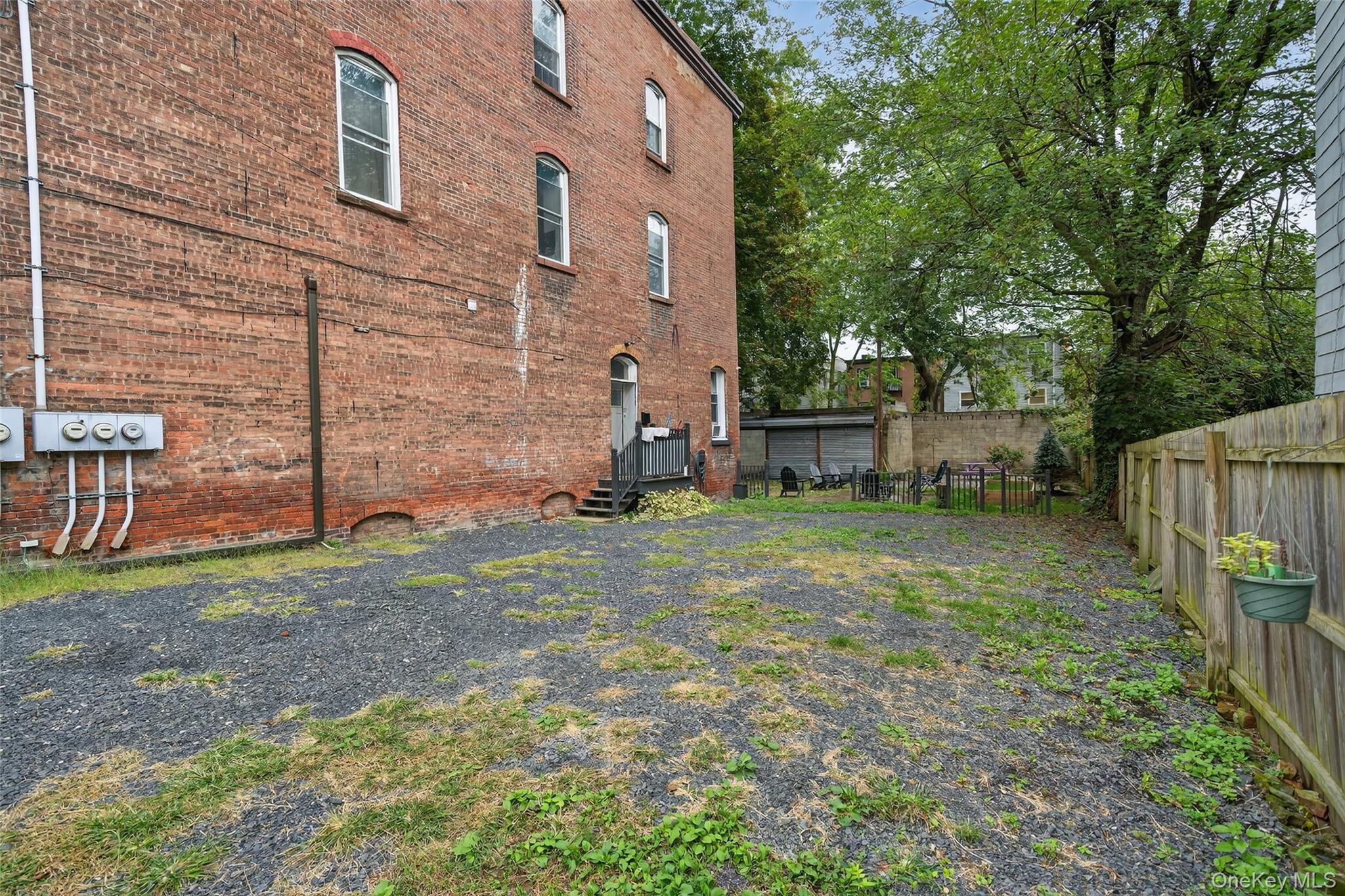 153 Lander Street Newburgh, NY 12550 - Photo 38 of 39 a backyard of a house with childrens swings and slides