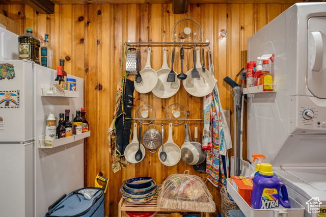 714 Spotted Fawn Way Kamas, UT 84036 - Photo 10 of 34 Detailed view of wooden walls, stacked washer and clothes dryer, and freestanding refrigerator