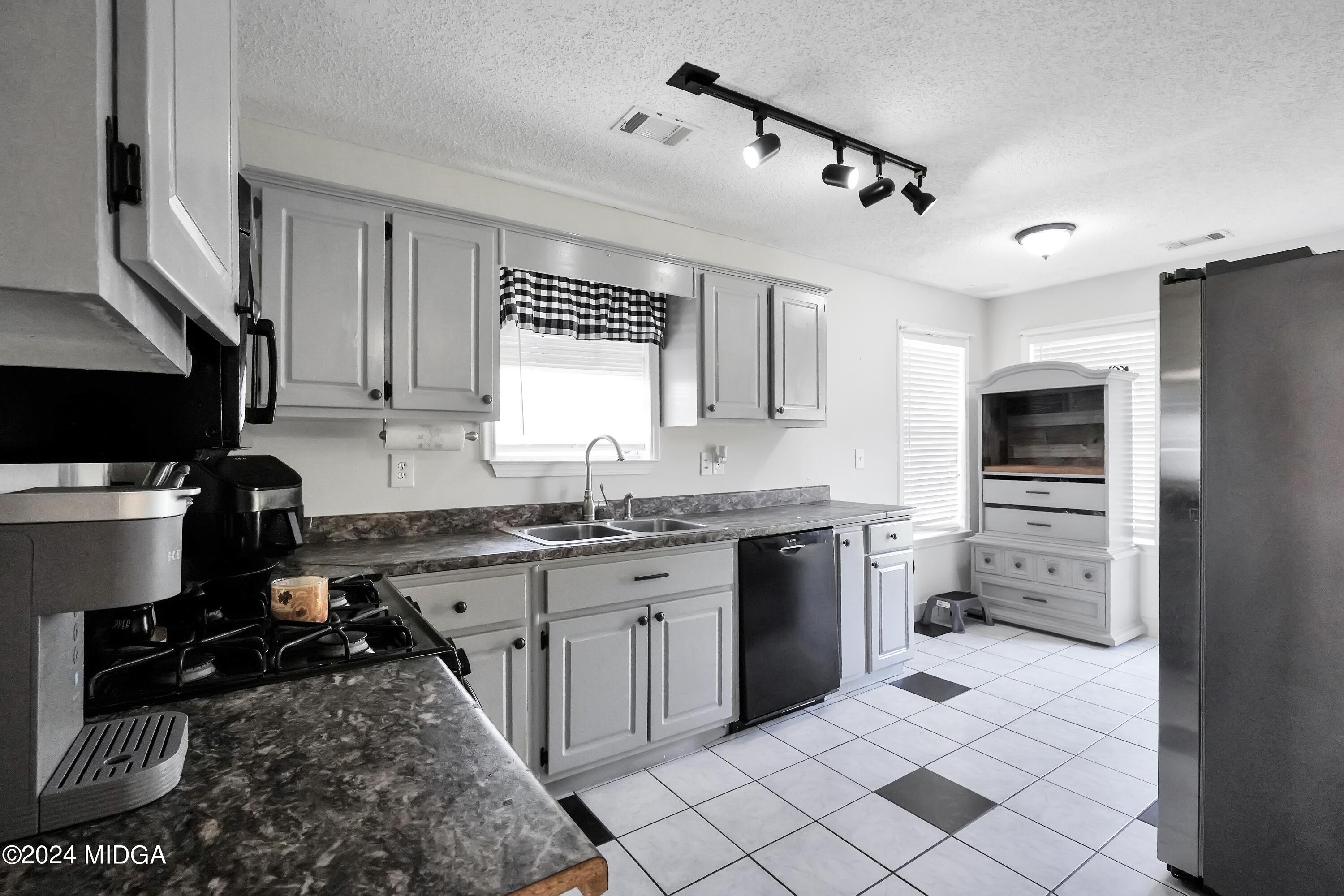 571 Regal Road Jackson, GA 30233 - Photo 5 of 21 a kitchen with a sink stove and refrigerator