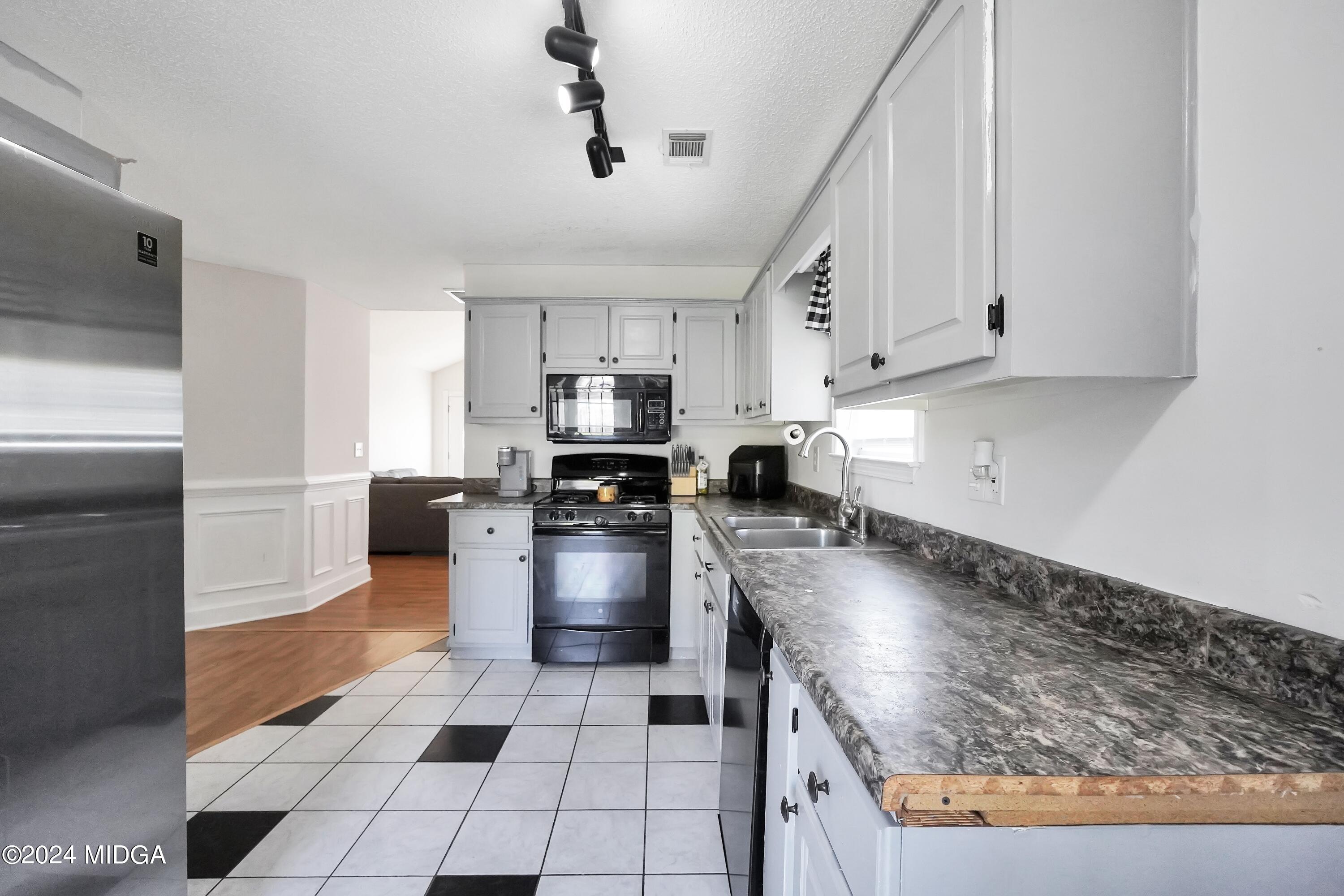 571 Regal Road Jackson, GA 30233 - Photo 7 of 21 a kitchen with stainless steel appliances granite countertop a sink a stove and cabinets