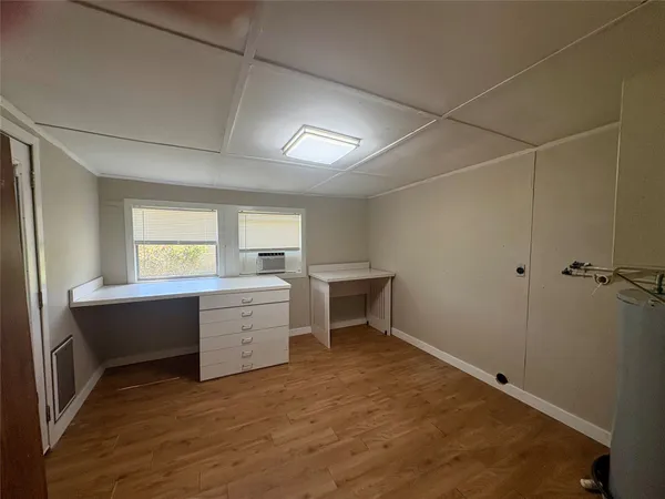a room with a window and dresser