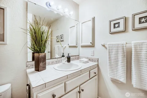 a bathroom with a sink a vanity and a mirror