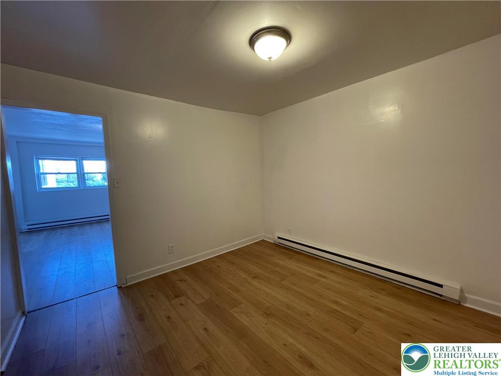 636 Ridge Avenue Allentown, PA 18102 - Photo 3 of 10 an empty room with wooden floor and windows