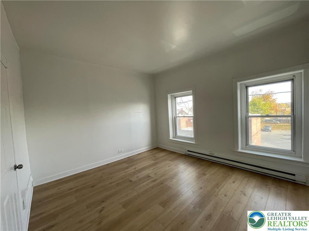636 Ridge Avenue Allentown, PA 18102 - Photo 10 of 10 an empty room with wooden floor and windows