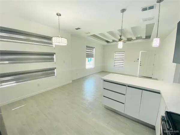 a room with a ceiling fan and a wooden floor