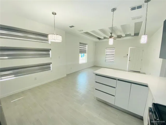 a room with a ceiling fan and a wooden floor