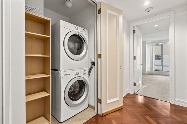 a view of a hallway with washer and dryer