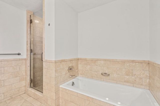 a bathroom with a bathtub and shower