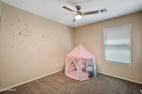 en empty room with window and ceiling fan