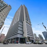 a view of a tall building next to a road