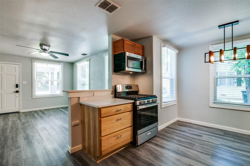 606 West High Street Terrell, TX 75160 - Photo 10 of 28 a kitchen with stainless steel appliances granite countertop a stove and a wooden floor