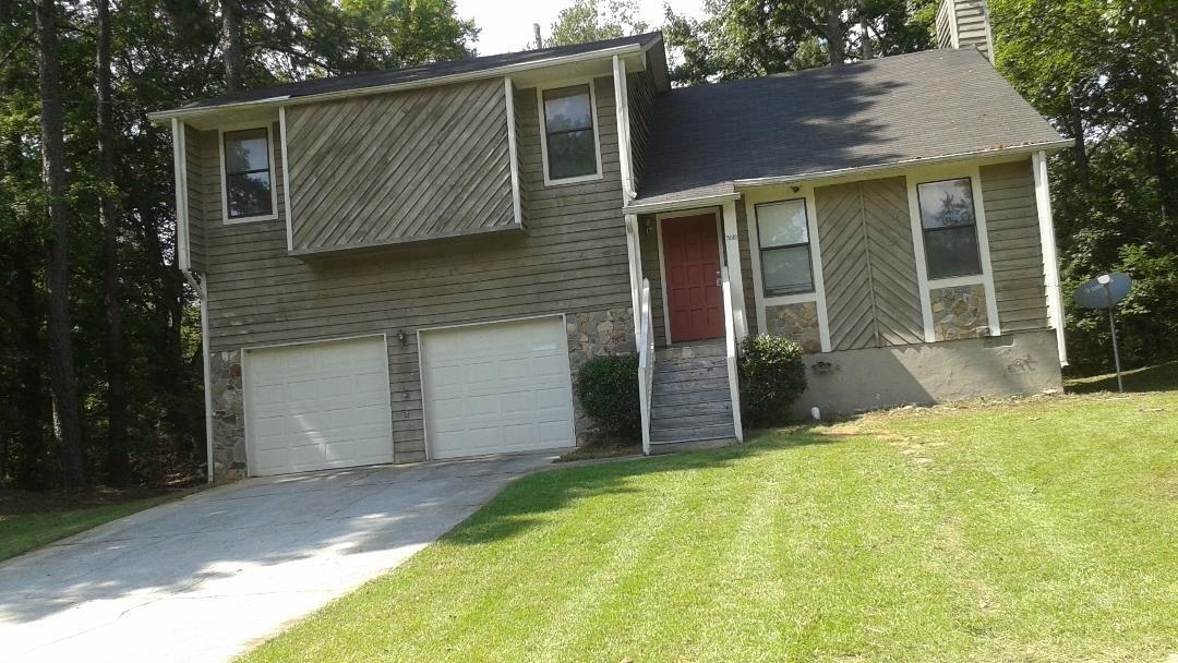 a backyard of a house with yard and garage