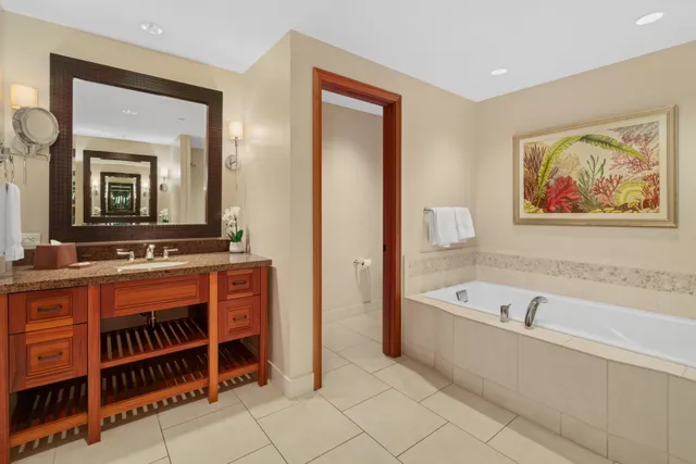 a bathroom with a bathtub a sink and a mirror