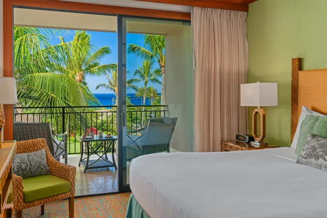 a bedroom with a bed a painting on the wall and a window