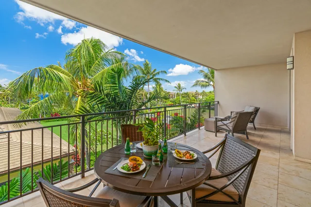 a view of a balcony with chair and potted plants