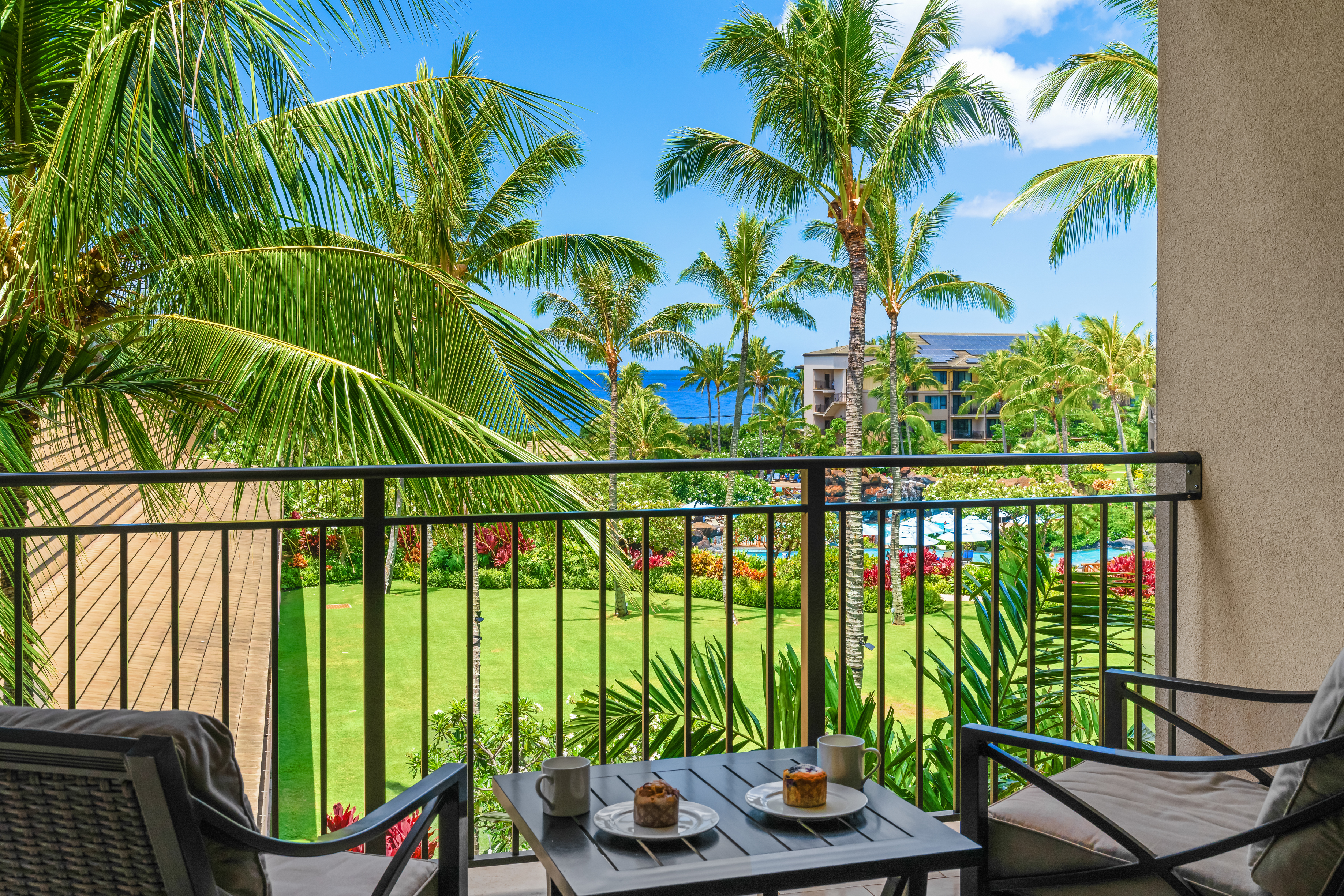 2641 Poipu Road, Unit 1202 Koloa, HI 96756 - Photo 23 of 30 a view of a swimming pool with a couches chairs and potted plants