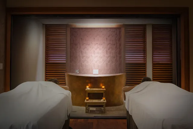 a bedroom with a bed and a lamp on dresser