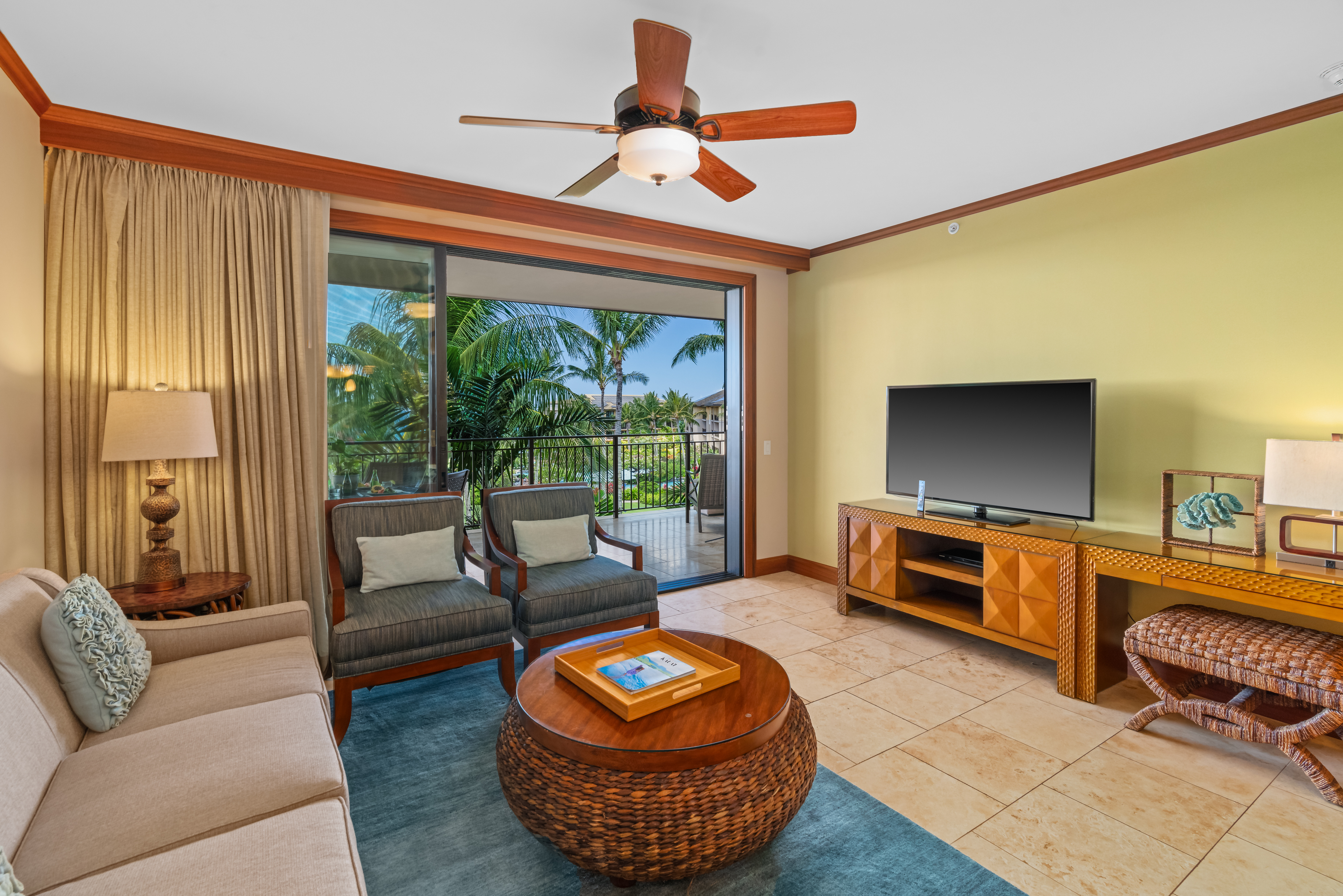 2641 Poipu Road, Unit 1202 Koloa, HI 96756 - Photo 6 of 30 a living room with furniture a flat screen tv and a floor to ceiling window