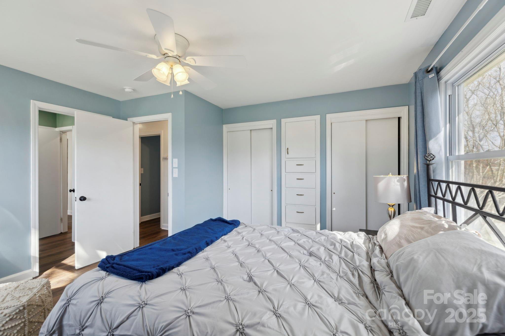 1450 Cane Creek Road Fletcher, NC 28732 - Photo 17 of 36 a bedroom with a large bed and a chandelier