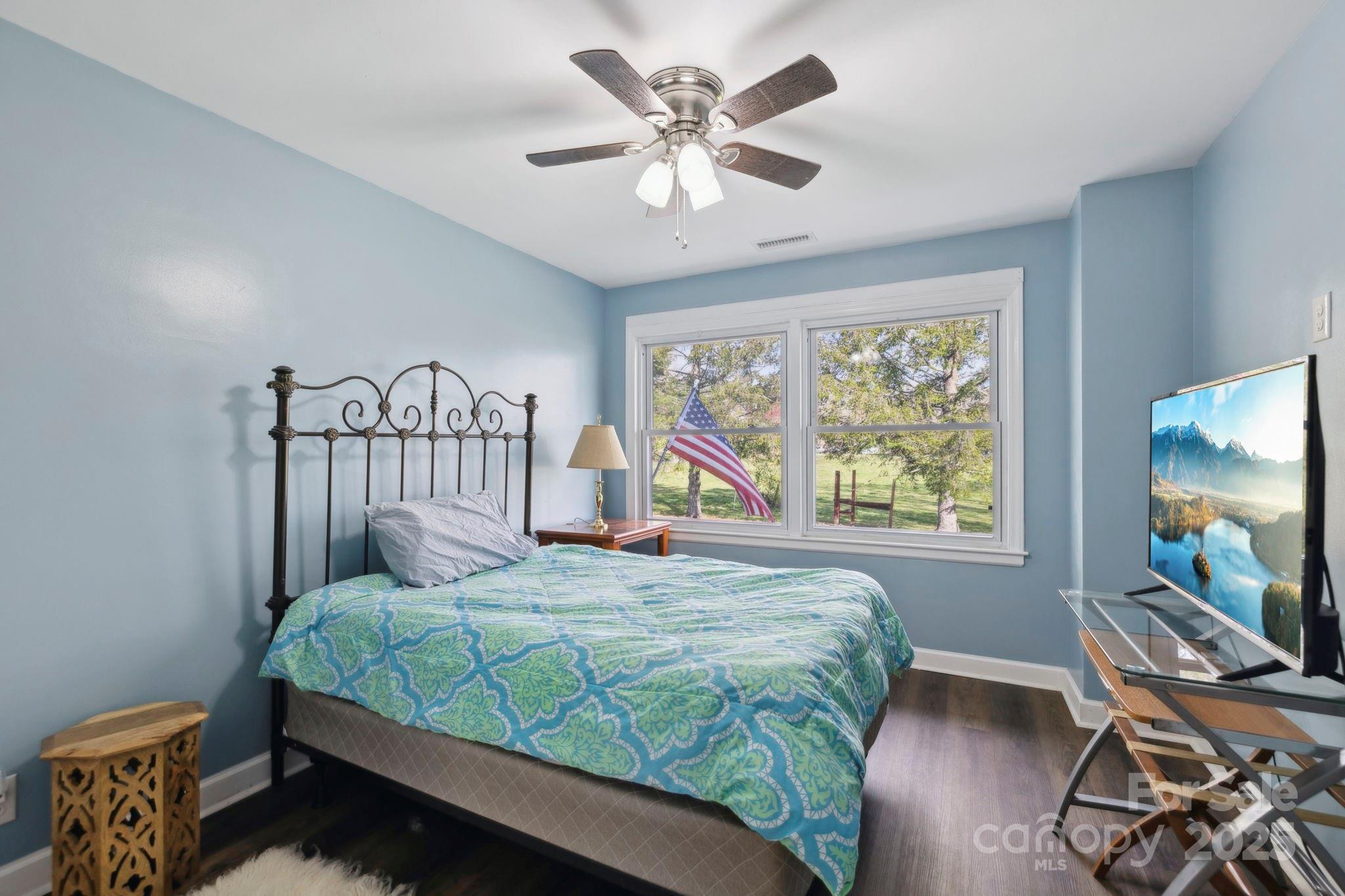 1450 Cane Creek Road Fletcher, NC 28732 - Photo 19 of 36 a bedroom with a bed and a flat screen tv