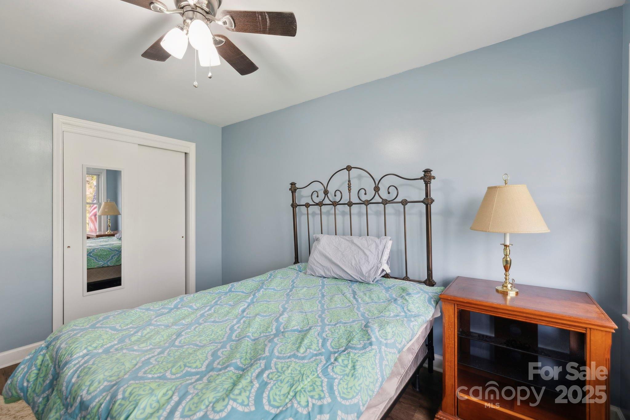 1450 Cane Creek Road Fletcher, NC 28732 - Photo 20 of 36 a bedroom with a bed and a chandelier