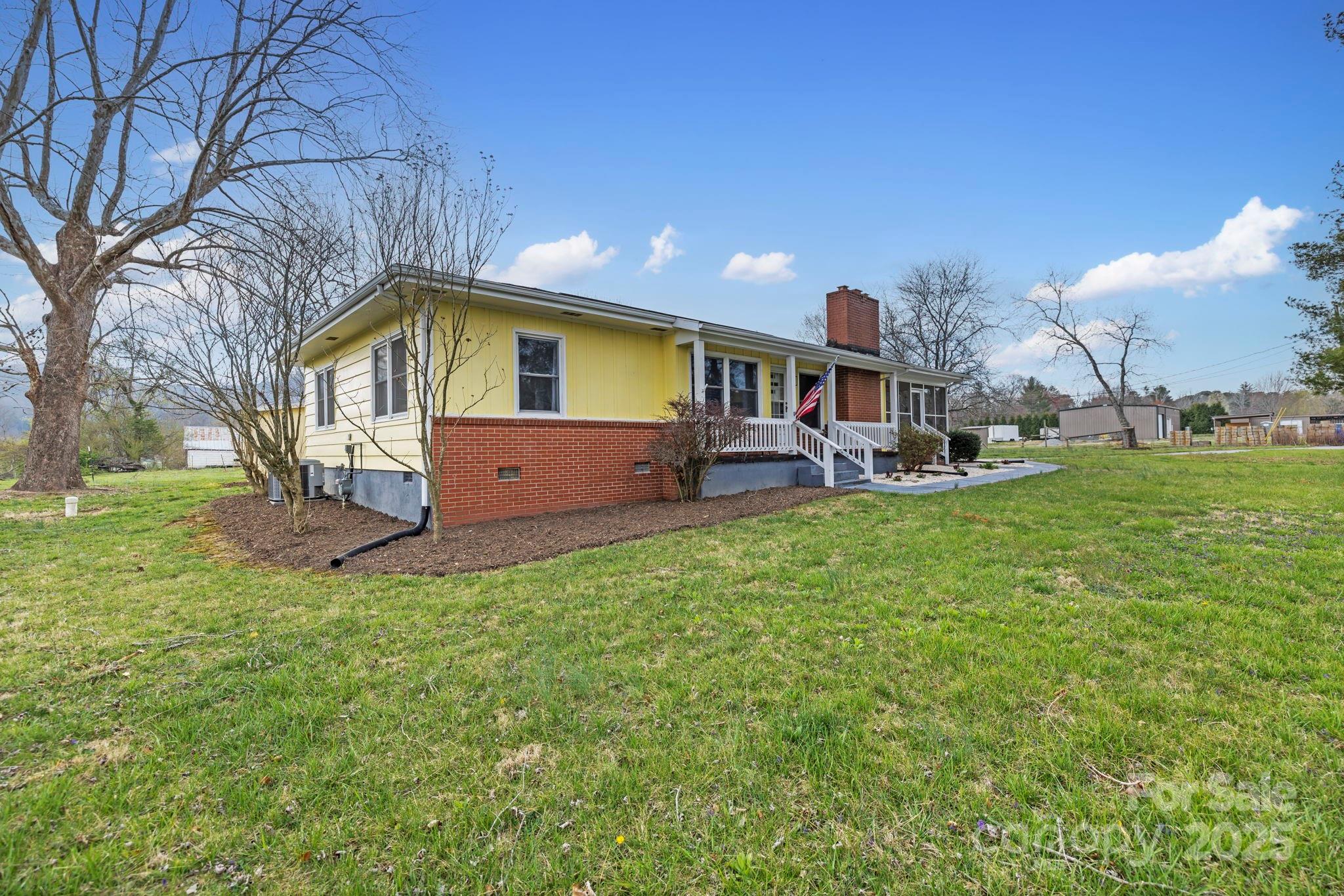 1450 Cane Creek Road Fletcher, NC 28732 - Photo 28 of 36 a view of a house with a yard