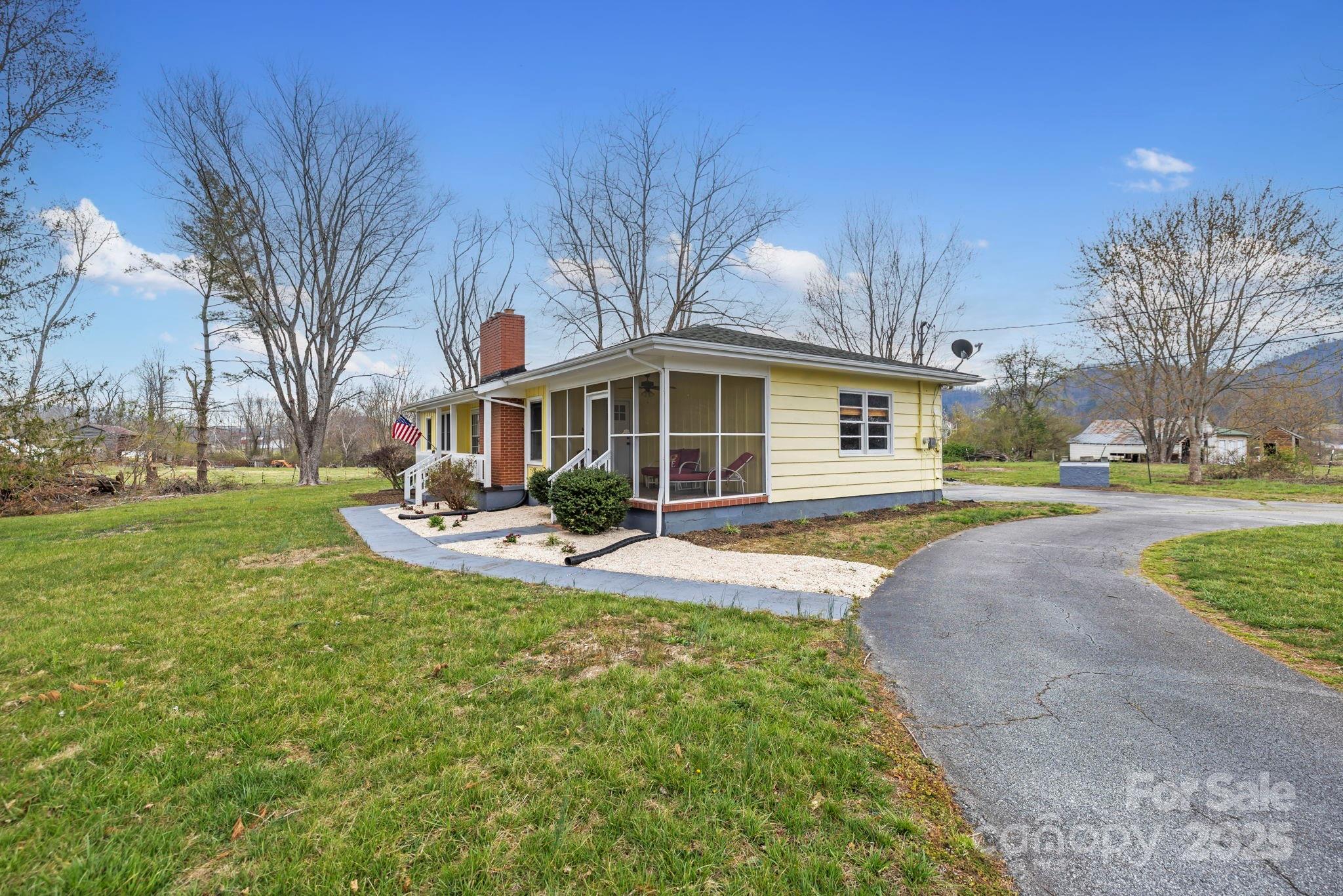 1450 Cane Creek Road Fletcher, NC 28732 - Photo 29 of 36 a front view of a house with a yard