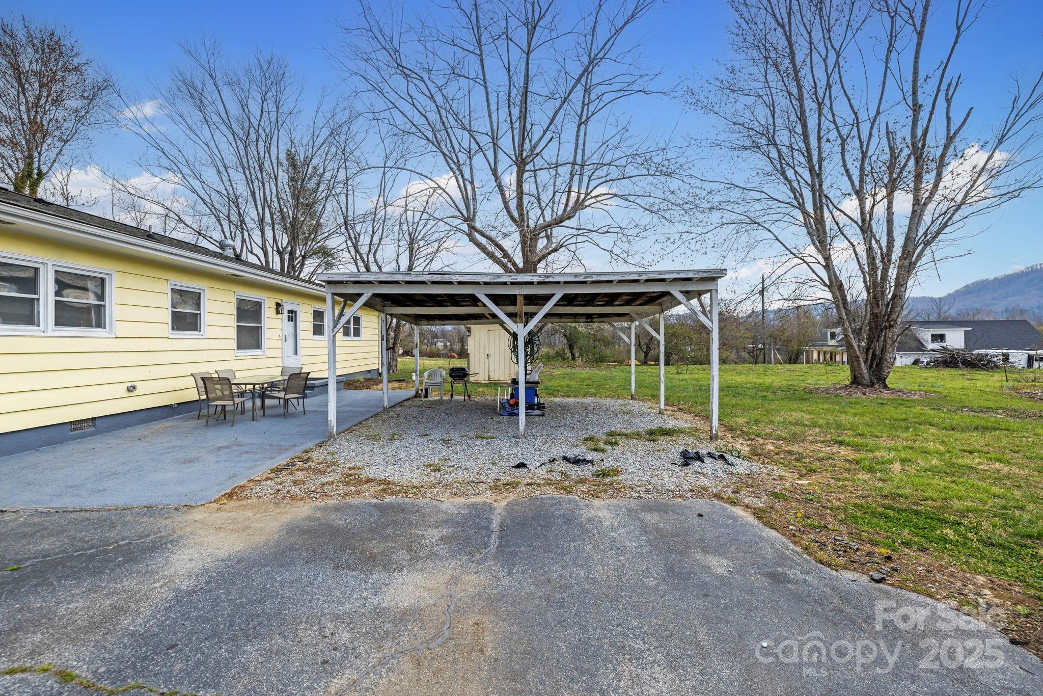 1450 Cane Creek Road Fletcher, NC 28732 - Photo 32 of 36 a view of a house with a backyard and trees