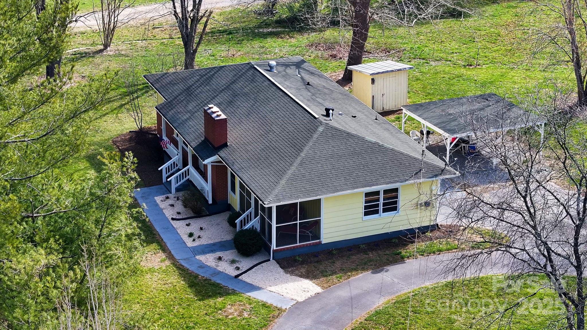 1450 Cane Creek Road Fletcher, NC 28732 - Photo 35 of 36 a aerial view of a house with a yard table and chairs