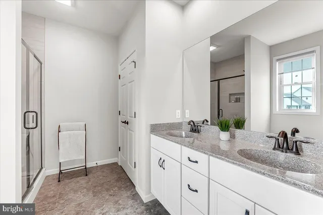 a en suite bathroom with double sink and a mirror
