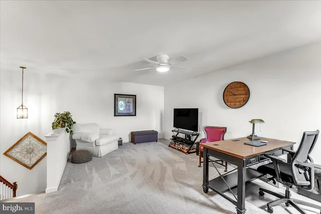 a living room with furniture a rug and a flat screen tv