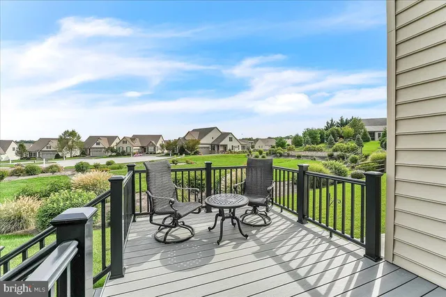 a view of a balcony with lake view and wooden floor