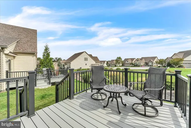 a view of a balcony with chairs and wooden floor