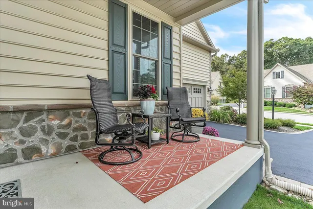a view of a patio with wooden chairs