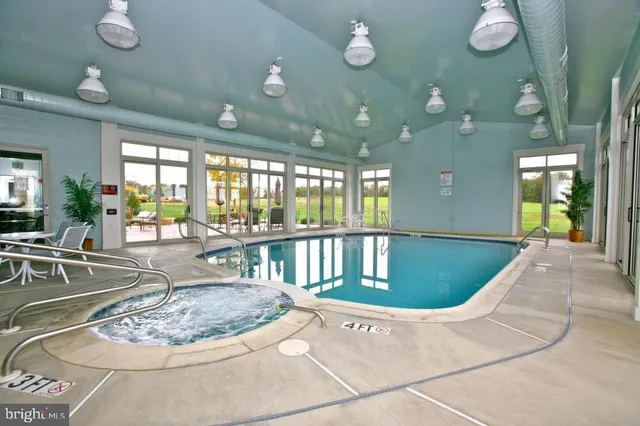 an aerial view of a swimming pool and outdoor seating
