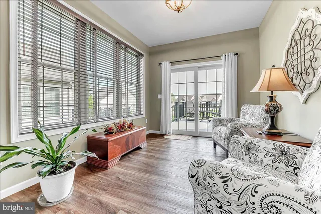 a living room with furniture and floor to ceiling windows