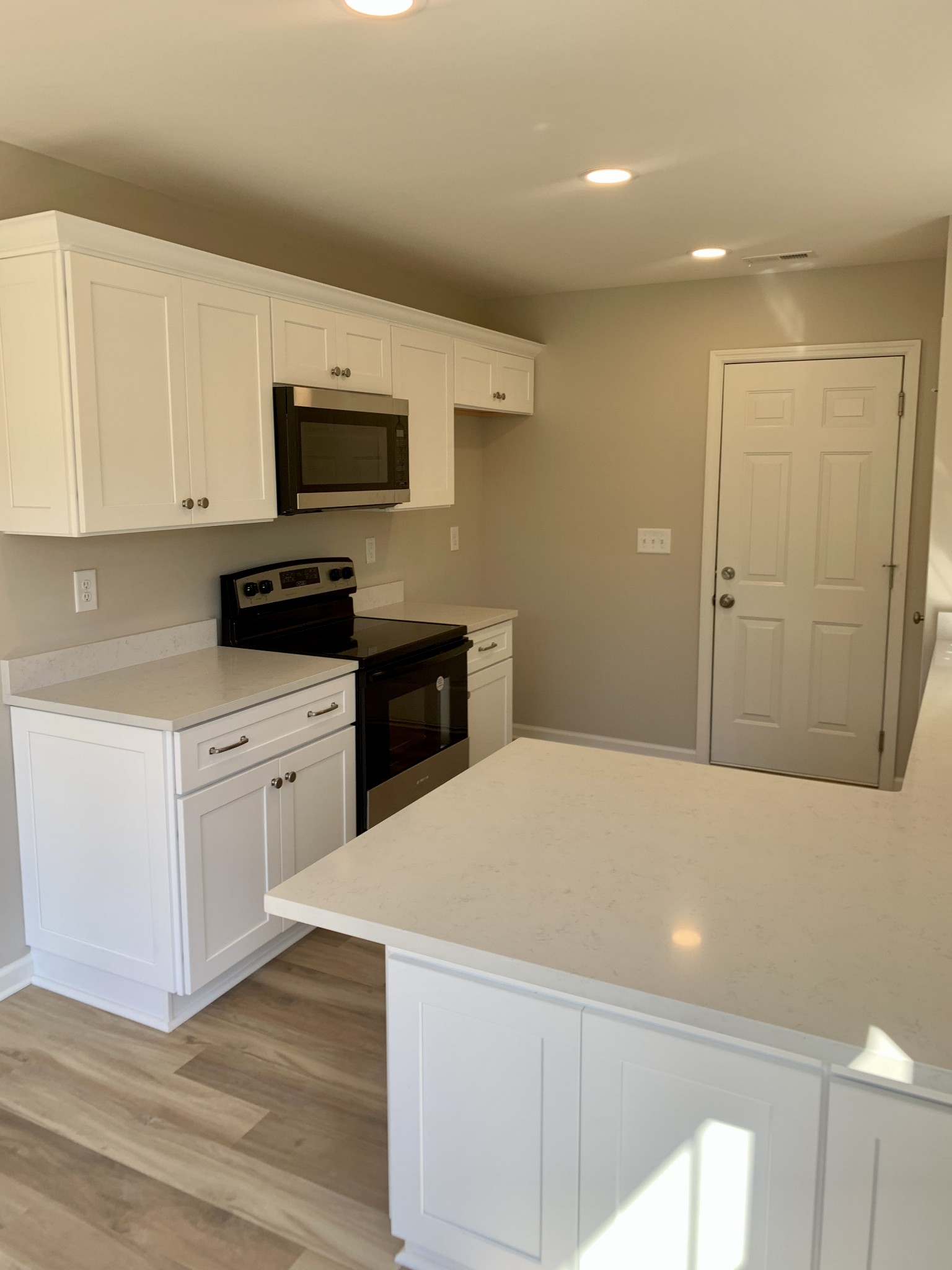 1897 Portway Road Spring Hill, TN 37174 - Photo 10 of 27 a kitchen with granite countertop white cabinets and stainless steel appliances