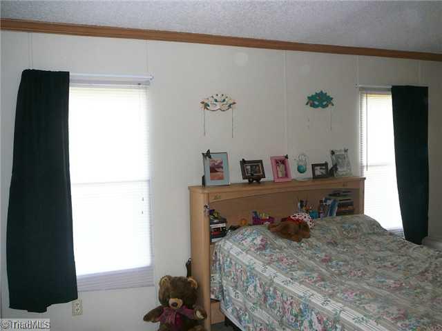 6792 Wright Road Thomasville, NC 27360 - Photo 8 of 16 Master Bedroom. Home features a split bedroom plan. The master is to the right of the living room and the other bedrooms are down a hallway to the left of the living room.
