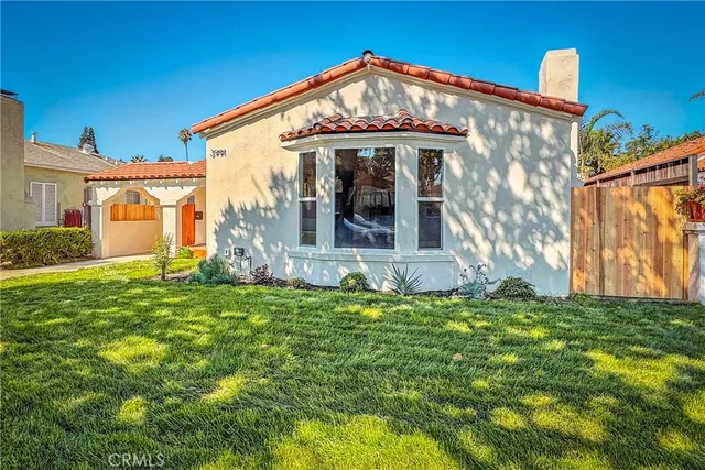 a view of a house with a small yard and a garden